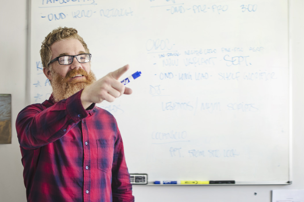 man teaching a class pointing to someone