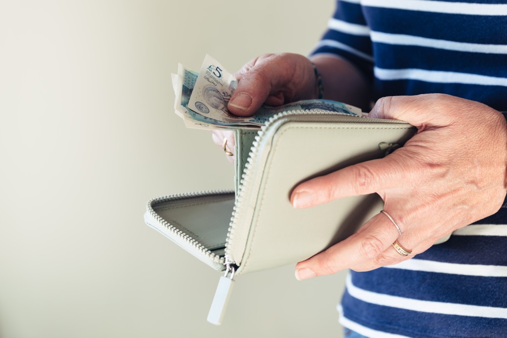 woman taking money out of her purse