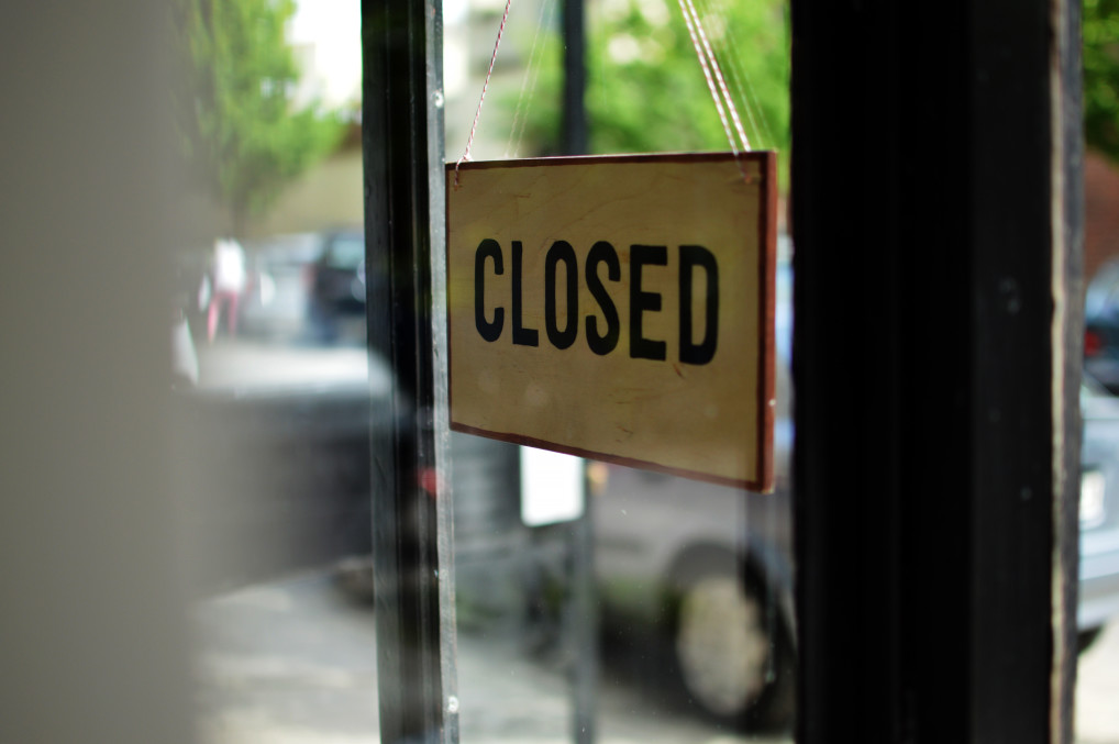 closed sign up on a shop door